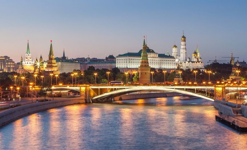 The Kremlin lit at dusk across the Moskva River, Moscow.