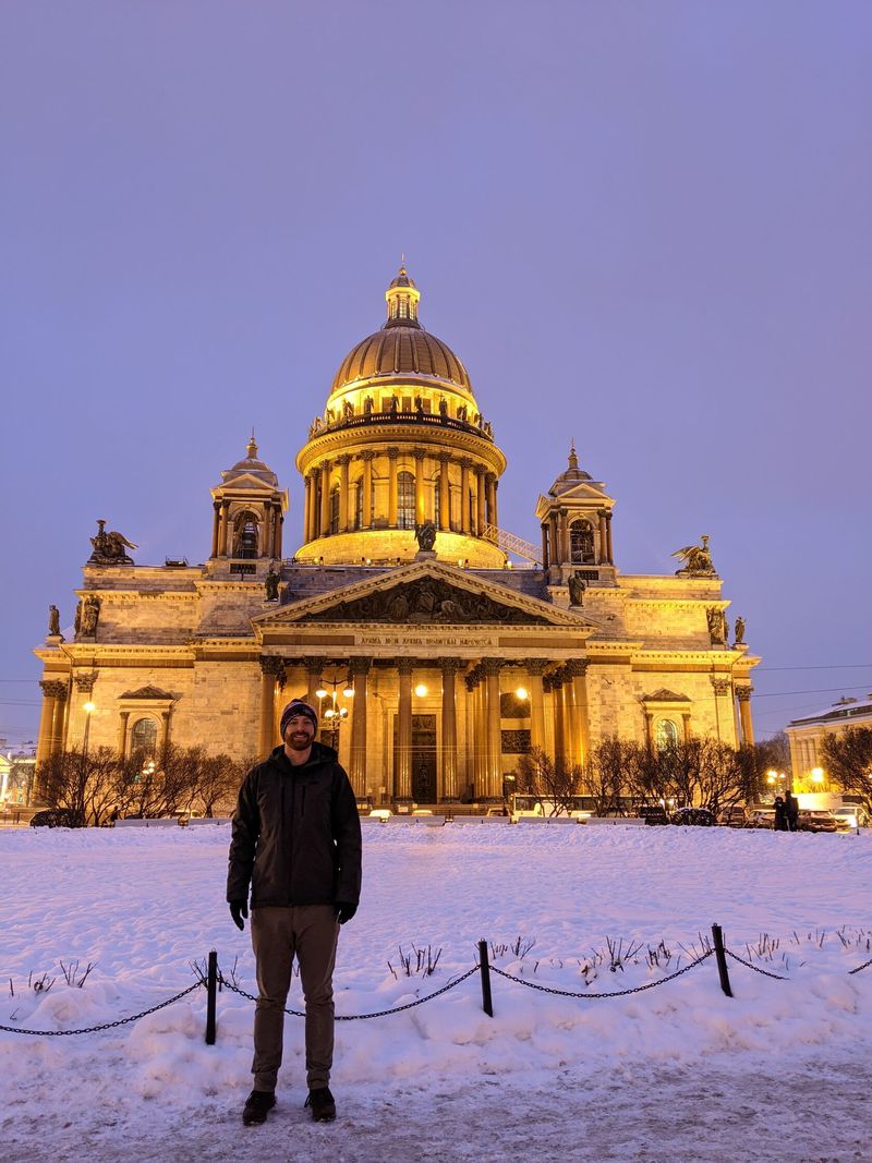 St Isaac's Cathedral lit gold against a violet dusk sky, St Petersburg.